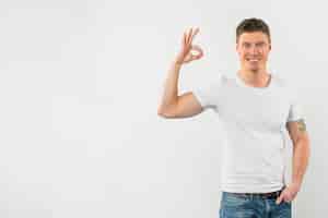 Free photo happy man showing ok sign against white background