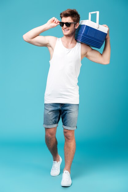 Happy man standing over blue isolated .