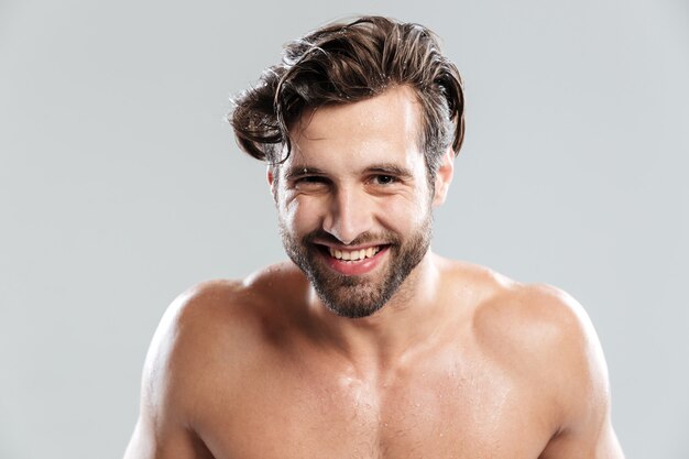 Happy man standing isolated over grey wall