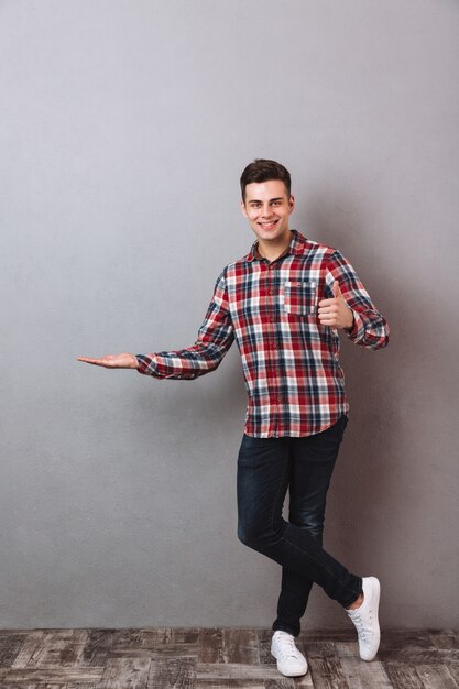 Happy man standing isolated with thumbs up