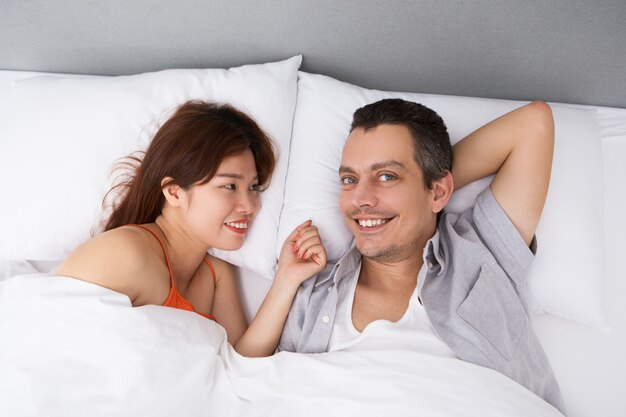 Happy man waking up with beloved wife