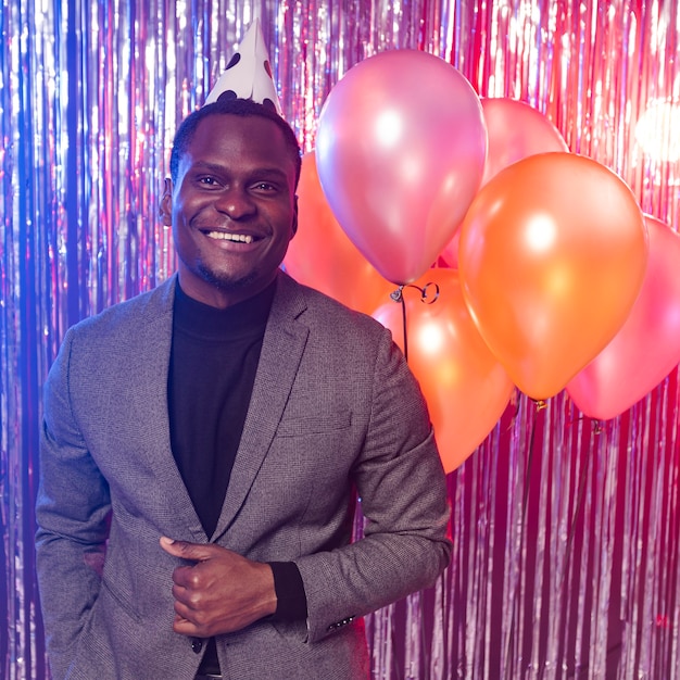 Happy man with balloons front view