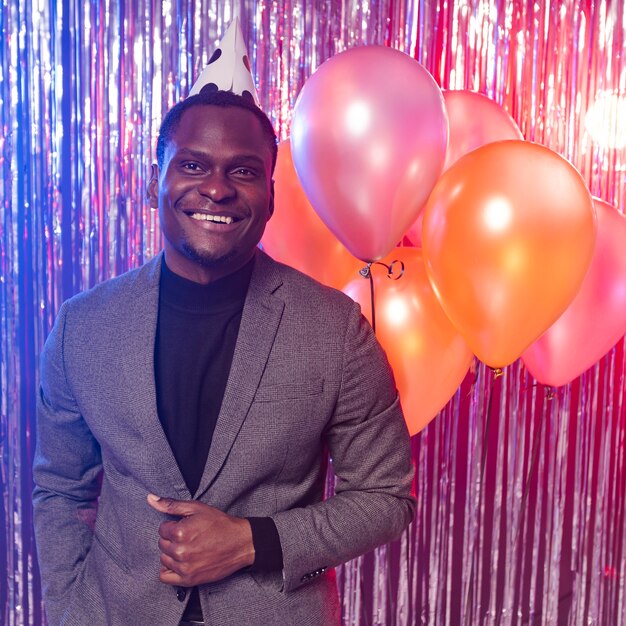 Happy man with balloons front view