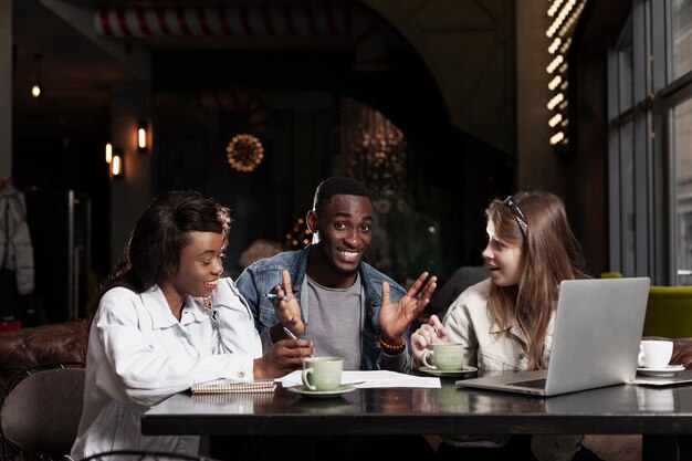 Happy man with friends indoors