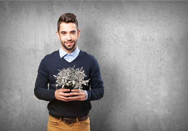 Happy man with a gray plant