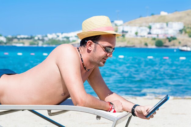 Happy man with hat using his smartphone