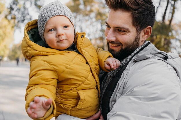 Happy man with his child outdoors in nature