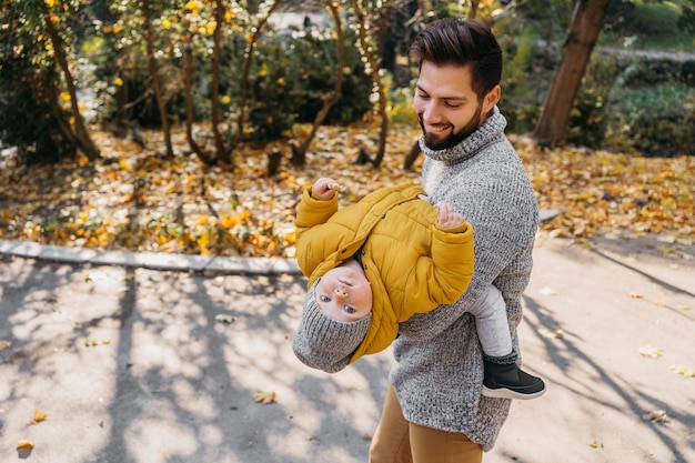 Happy man with his child outdoors