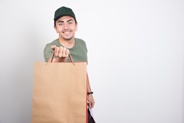 Happy man with shopping bags against white background.