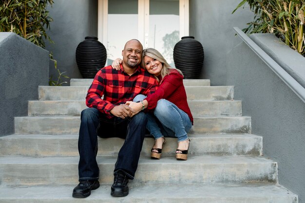 Happy married couple holding hands on the front porch