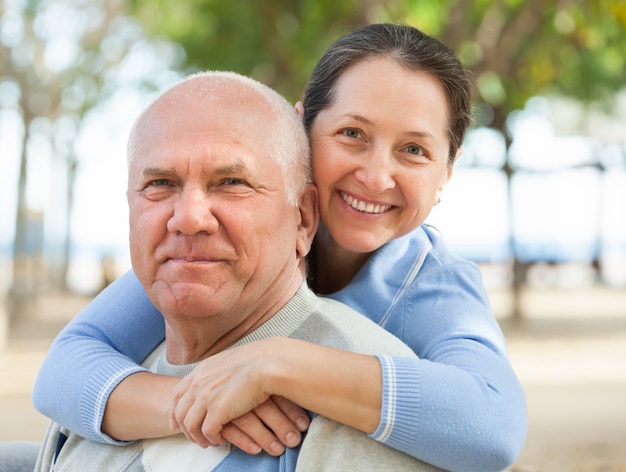 Happy mature couple together in autumn park