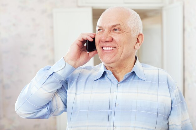 happy mature man speaks by phone