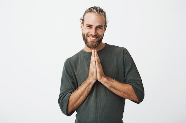 Happy mature swedish guy feeling extremely guilty, asking to forgive