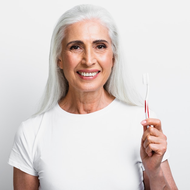 Happy mature woman holding tootbrush