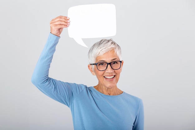 Happy mature woman showing sign speech bubble banner looking happy