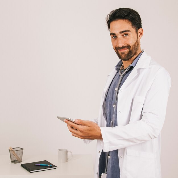 Happy medical doctor working with the ipad