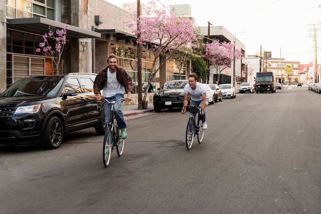 Happy men riding bicycles in city