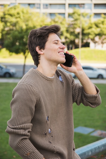 Happy mid adult man talking on cell phone