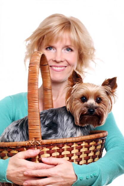 Happy mid age woman ang her yorkshire terrier