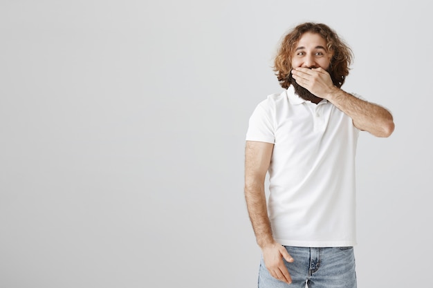 Free photo happy middle-eastern man cover mouth, laughing