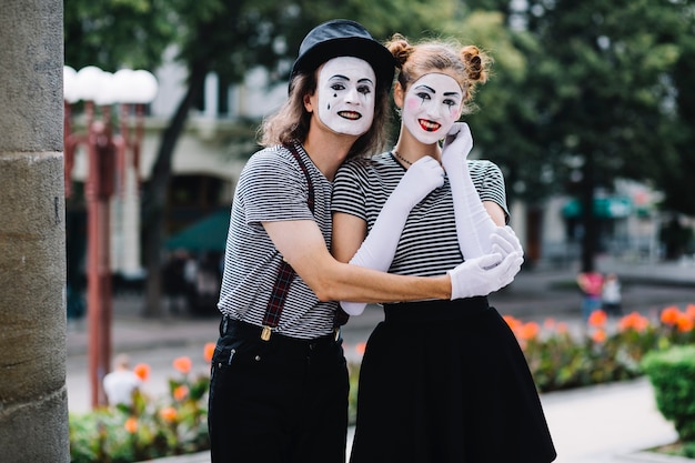 Free photo happy mime couple embracing each other