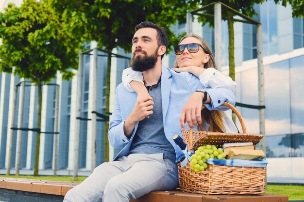 デートの幸せな現代のカップルは、街でピクニックをします。