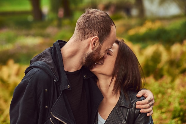 Happy modern couple in the park. Enjoying their love and nature.