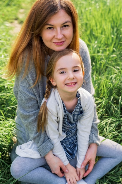 Happy mom and daughter outdoors