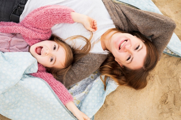 Happy mom and daughter top view