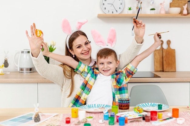 Happy mom and son with rabbit ears