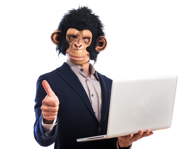 Happy monkey man holding a laptop