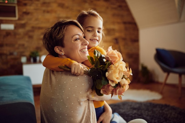 happy mother and daughter embracing at home