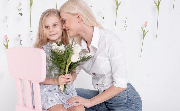 Happy mother and daughter front view