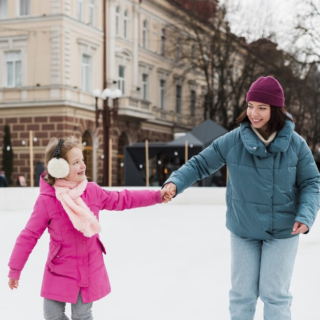 Happy mother and daughter holding hands