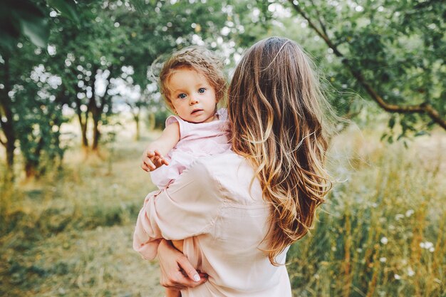 Happy mother and daughter laughing together outdoors