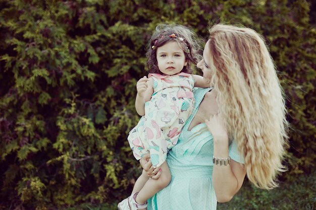 Happy mother and daughter laughing together outdoors