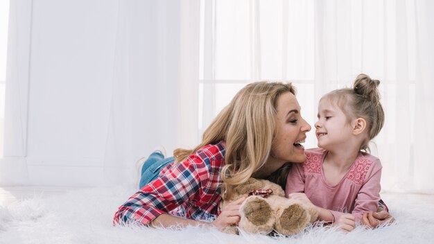 Happy mother and daughter looking at each other