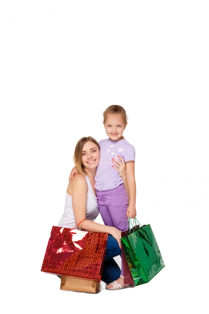 Happy a mother and daughter with shopping bags