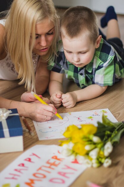 Happy mother drawing with her son