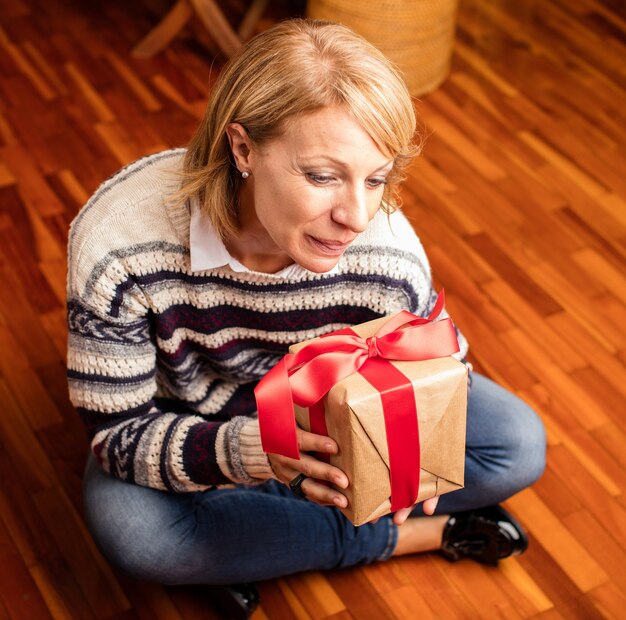 Happy mother opening a christmas present