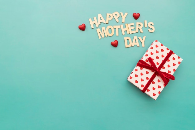 "happy mother's day" lettering with hearts and gift box