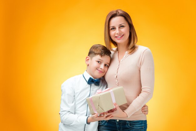 Happy mother and son with gift box