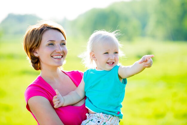 Happy mother and toddler son at field -  outdoor portrait