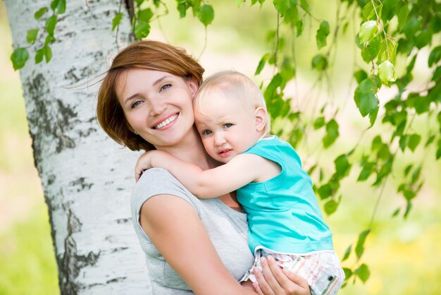 Happy mother and toddler son at field -  outdoor portrait