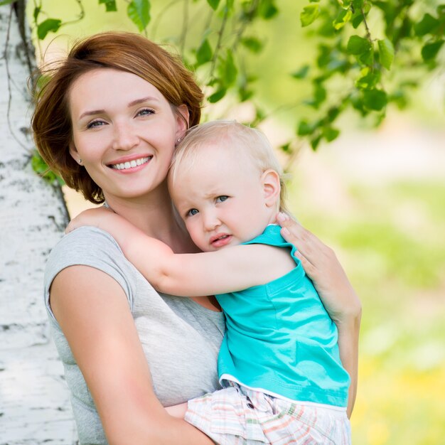 Happy mother and toddler son at field -  outdoor portrait