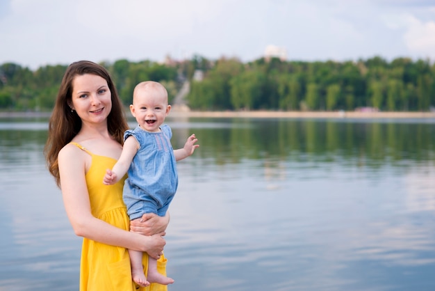 Happy mother with kid in nature