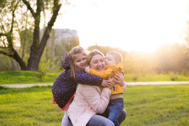 Happy mother with kids in nature