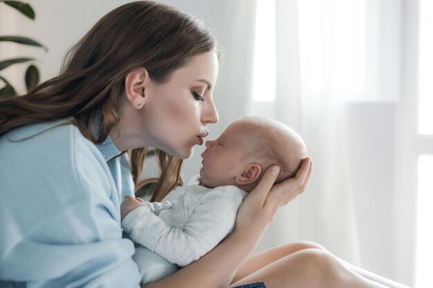 happy mother with newborn at home