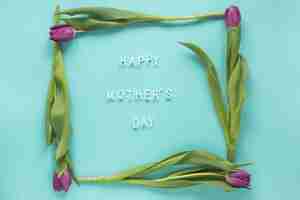 Free photo happy mothers day inscription in frame from tulips