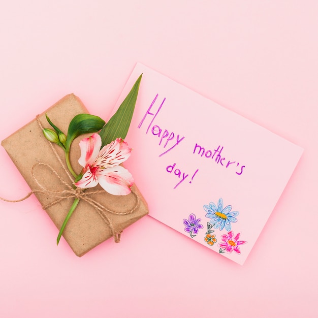 Happy Mothers Day inscription with flower and gift